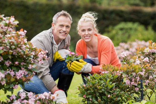 Operative using PPE while performing garden maintenance